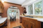 Sprawling kitchen has double ovens, a gas range, and plenty of work space